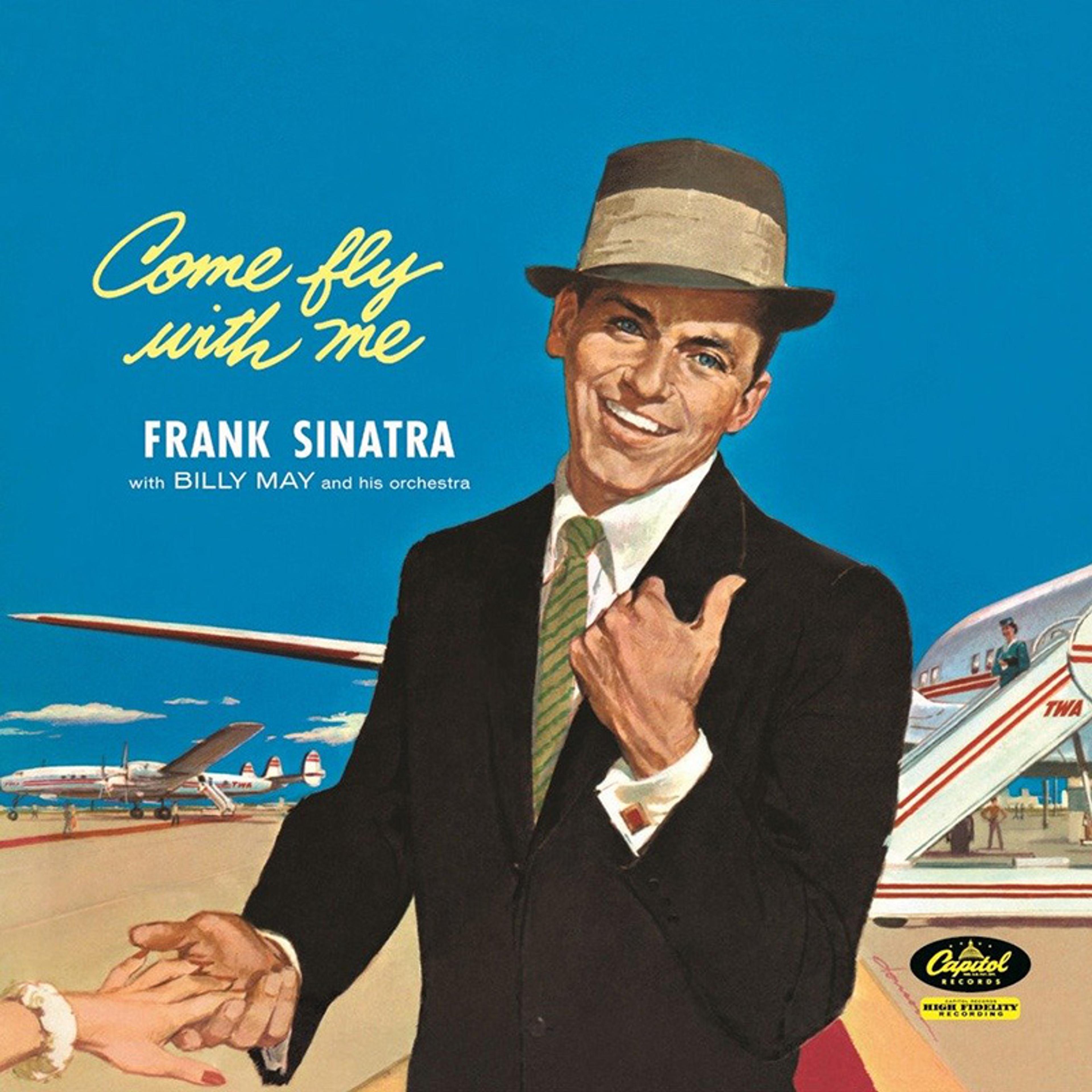 Album cover painting of “Come Fly With Me” depicting a smiling man in a suit and hat near a TWA aeroplane against a blue sky.